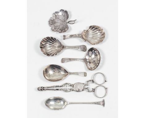 A George III silver caddy spoon with shell pattern bowl and scroll handle by Tudor & Leader, Sheffield 1786, a ditto with she