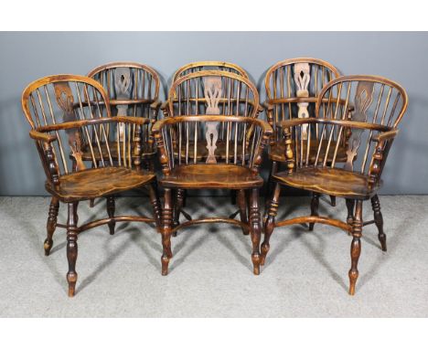A Harlequin set of six 19th Century "Nottinghamshire" ash and elm low two tier stick back Windsor armchairs all with arched c