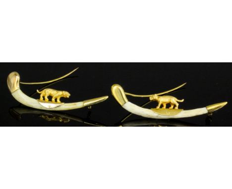 Two early 20th Century bone and gold coloured metal mounted tie pins of curved form, each surmounted by a cast figure of a  t