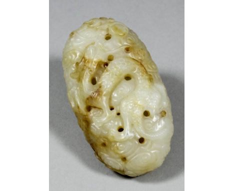 A Chinese pale celadon jade oval bead pendant with slight brown inclusions, pierced and carved with a dragon to one side and 