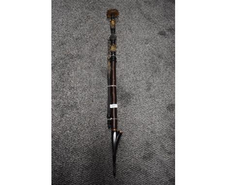 An antique continental tobacco pipe having wood shaft and horn banding.
