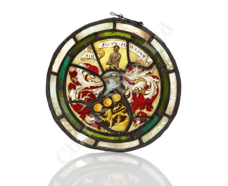 A 19TH CENTURY STAINED GLASS ROUNDEL BEARING THE ARMS OF ADMIRAL SIR JOHN HAWKINS, in etched and coloured glass with lead lin
