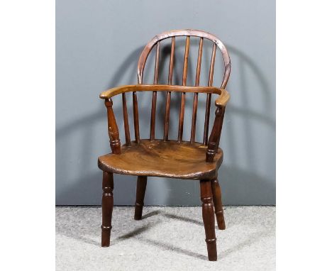 A 19th Century child's yewwood, ash and elm seated two tier stick back Windsor armchair on turned legs