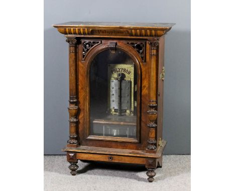 A late Victorian walnut cased "Penny in the Slot" Polyphon to take 19.75ins diameter metal disks, the mechanism with twin ste