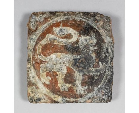 A Wessex School  Medieval encaustic tile decorated with a white slip inlay with an heraldic lion passant facing right within 