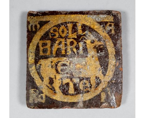 An English Medieval encaustic tile decorated with a white slip inlay of a sign of the Zodiac with the inscription "Soli Bari 
