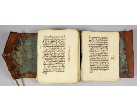 A 19th Century manuscript copy of the Koran in West African Arabic script (probably Nigerian), the 9ins x 6.75ins pages enhan