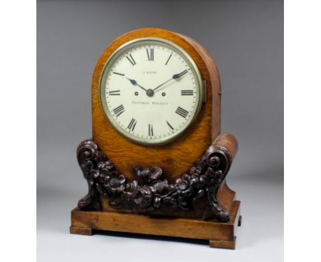 A William IV pollard oak mantel clock by J. Kent of Saffron Walden, the 8ins diameter circular painted metal dial to the eigh