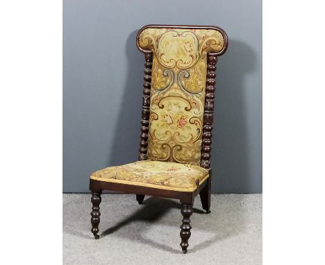 A Victorian mahogany framed low nursing chair with moulded frame on bobbin turned and carved uprights, the seat and back upho