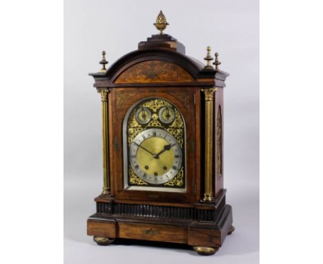 A late 19th Century German brass inlaid rosewood mantel clock, the arched brass dial with 7ins diameter silvered chapter ring