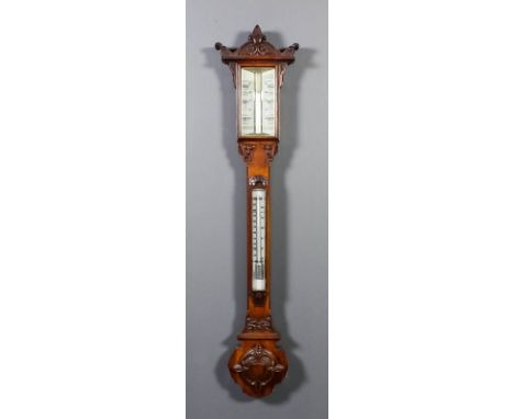 A late Victorian oak cased stick barometer and thermometer with white opaque glass scales and vernier mercury thermometer, co