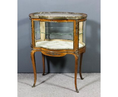 An early 20th Century French kingwood and gilt brass mounted oval vitrine of shaped outline with moulded leaf pattern mount, 