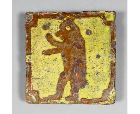 A Medieval encaustic tile decorated with a standing bear against a yellow slip inlay, 5.375ins square