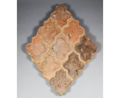 A French Medieval relief decorated nine tile panel of human heads, some with animal head-dresses, mounted on a board  23.5ins