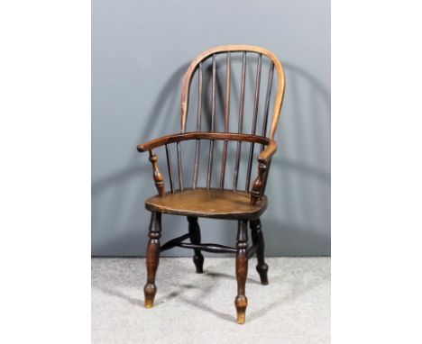 A 19th Century child's ash and beechwood two tier stick back Windsor armchair with high arched back, wood seat, on turned und