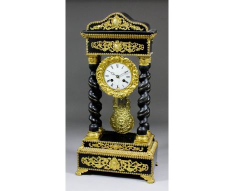 A 19th Century French ebonised and gilt metal mounted mantel clock of "Empire" design, the 3.5ins diameter white enamelled di