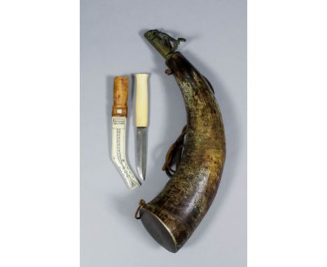 A 19th Century powder horn with a pair of steel rings for suspension and brass nozzle, 12ins long, and a 20th Century Inuit k