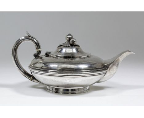 An early Victorian silver teapot, the squat circular body with moulded girdle and cast fruit and leaf pattern finial, scroll 