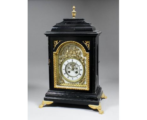 A late 19th Century French ebonised mantel clock, the arched dial with 2.5ins diameter enamelled chapter ring with Roman nume