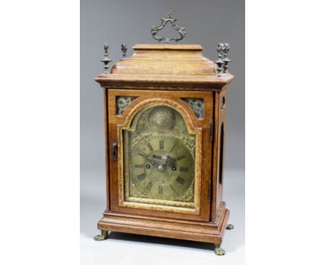 A late 19th Century oak cased mantel clock of early 18th Century design, the 5ins arched brass dial with wide chapter ring wi