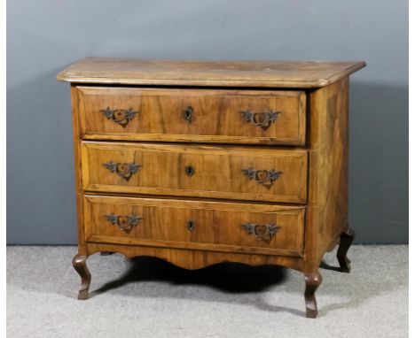 An 18th Century North Italian walnut commode, the quarter veneered top with shaped central panel inlaid with boxwood stringin