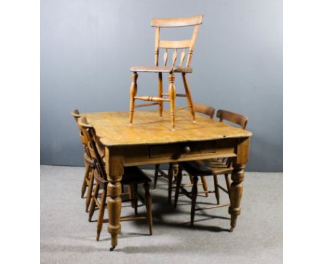 A Victorian pine kitchen table with four plank top, fitted drawer to one end, on heavy turned supports, 53ins x 42ins x 30ins