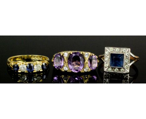 A modern 18ct gold mounted sapphire and diamond five stone ring, the central sapphire approximately .15ct bordered by two bri