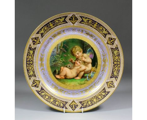 A "Vienna" porcelain charger, the centre painted with cupid, a child and a puppy, within a raised gilt border on a lilac grou