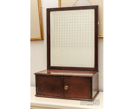 A Victorian toilet mirror, the bevelled plate within reeded edge, rectangular frame above hinged cupboard doors, 44.5 x 28.5 