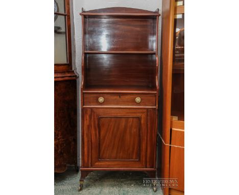 A small Regency solid mahogany waterfall bookcase, c1820, the three graduated shelves with a small drawer and cupboard below 