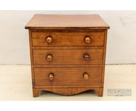 An oak low chest or commode, with lift up lid and brass carry handles, cross banded to resemble a chest of drawers with bun h