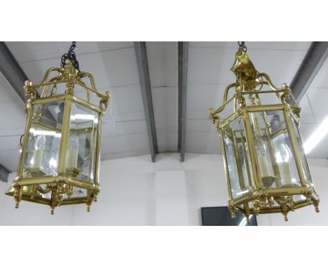 A pair of hexagonal brass and glass panelled lantern light fitting, 34 x 67cm (2)