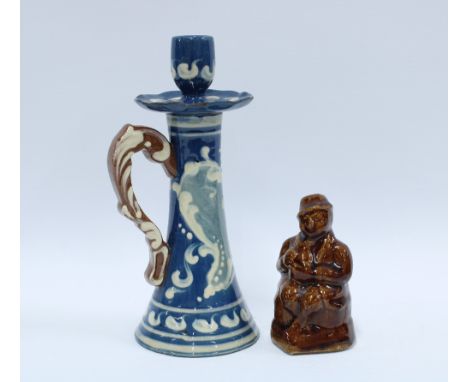 Scottish pottery figural money man and a Torquay pottery chamber candlestick (2) 23cm. 