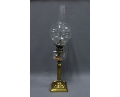 Brass oil lamp with a BEC Gladiator glass well, complete with funnel and glass shade, overall height 75cm 