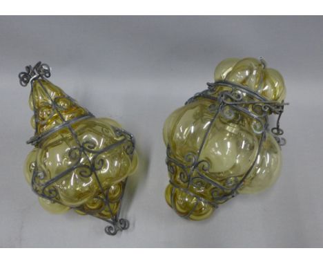A pair of moulded glass and black metal shades, on with a light fitting inside, 28cm long (2)
