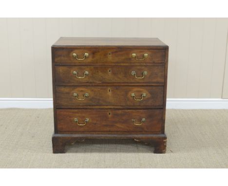 A George III mahogany Dressing Chest with cross-banded caddy top above fitted top drawer, three long graduated drawers beneat