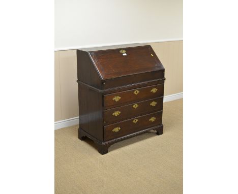 An antique oak Bureau, the upper fall front section enclosing fitted drawers and an arched recess, the lower section fitted t