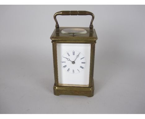 A late 19th Century brass cased Carriage Clock with white enamel dial, lever escapement with repeater mechanism, 6 1/2 in
