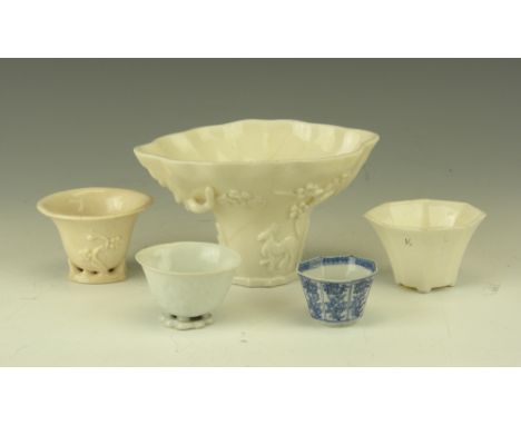 A group of Chinese porcelain Drinking Vessels, comprising a Kangxi blanc de chine rhino horn form libation cup, decorated wit