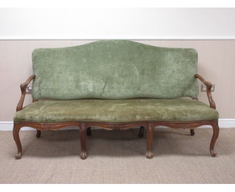 An Italian walnut Sofa with green upholstered shaped back and seat on eight cabriole supports, one leg A/F, 6ft W