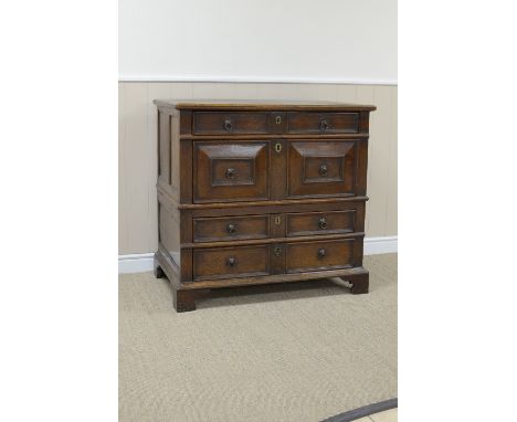 A Jacobean moulded oak Chest of four long drawers with four plank top with replaced section, the two sections split between t