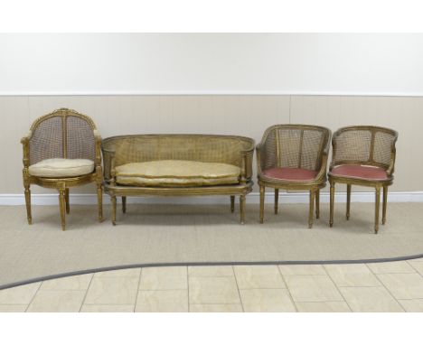 A Louis XVI style gilt framed Settee with double cane panelled back, loose squab cushion on spiral turned front legs, 4ft 4in