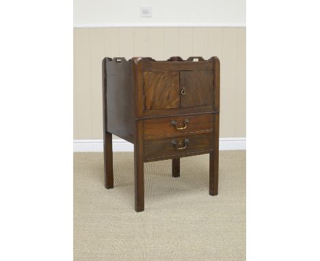 A George III mahogany Commode having gallery with hand holds above pair of doors, drawer and dummy drawer on square supports,