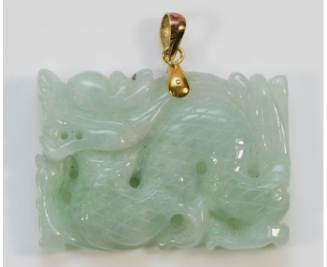 A 14K carved jade pendant in the form of a Chinese dragon, 35mm, 13.4g