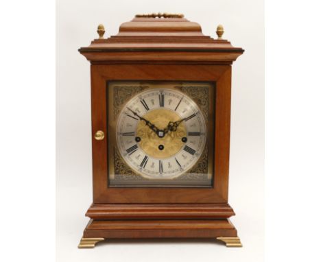 Franz Hermle; A German mahogany cased chiming mantel clock, with a glazed hinged door protecting a silvered chapter ring feat