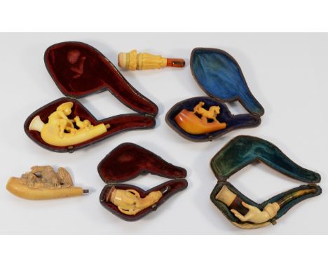 Six 20th Century meerschaum smoking pipes/cigarette holders, four of which are housed in fitted cases, forms to include a han