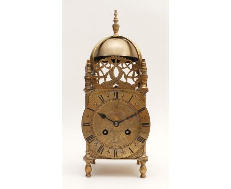 An early 20th Century brass lantern clock, in the style of Charles II, fretwork panels atop three sides, the front panel depi