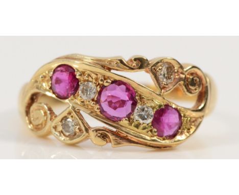 An 18ct gold ruby and brilliant cut diamond dress ring, hallmarks have been polished away, Q, 3.4g