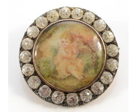 An unmarked Victorian 9ct gold and silver set paste brooch with a painted portrait of a child to the centre, 28mm, 8.2g