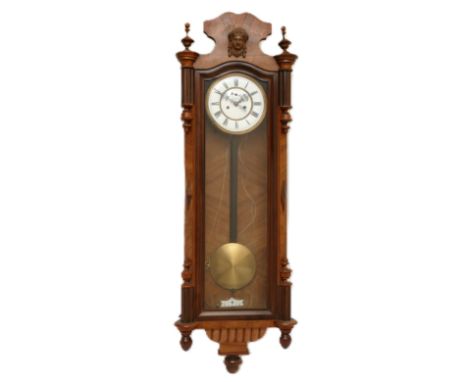 An early 20th Century double weight Vienna style regulator, walnut and mahogany cased, with an enamel dial featuring a subsid